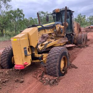 Yellow tractor stuck in mud