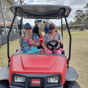 BDS Mechanical Repairs Middlemount at the @AG Middlemount Charity Golf Day 2023. 2 ladies in a red gold buggy