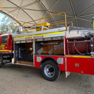 Red fire truck parked outside under a tent in Rockhampton
