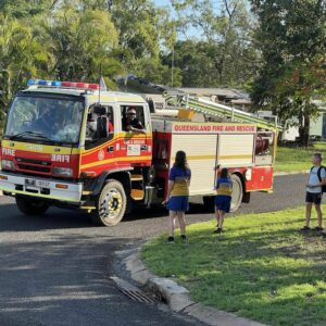 BDS Mechanical Repairs Middlemount sponsoring the Santa Lolly Drop - picture of the fire truck dropping off lollies the children in the streets