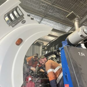 Two mechanics working on a large white truck at BDS Mechanical Repairs Cairns workshop