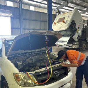 BDS Mechanical Repairs Cairns Auto Electrician inspecting a white vehicle under the hood